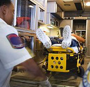 God's help in crisis - Photo of person being lifted into an ambulance to raise the question of what God can do to help in times of crisis.