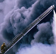 In real crisis can God help - Photo of fireman ascending a ladder in a billow of smoke, illustrating danger and alarm, and God being our only sure peace.