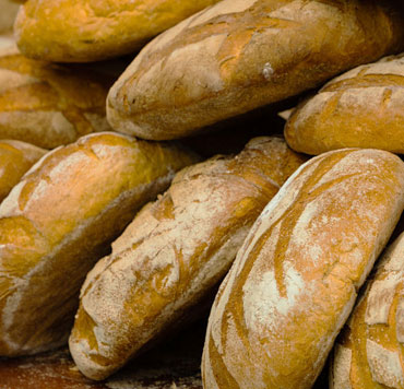 Loaves of bread - Photo of a pile of loaves of bread to illustrate Jesus' miracle of multiplying loaves of bread to feed 5,000 people.