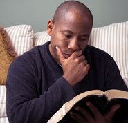 Photo of a man reading the Bible to illustrate that God has revealed his existence to us in the Bible.