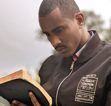 A young man reading the Bible