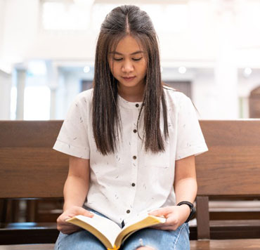 A young woman reading the Bible