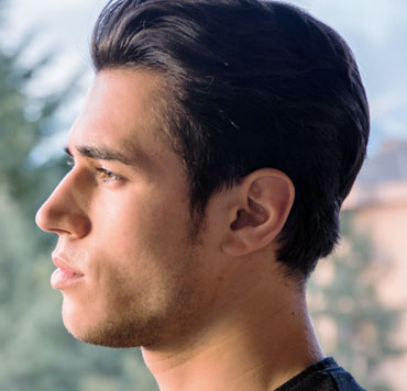 Photo of a man thinking, to illustrate the human brain's ability to process a million messages a second, an amazing ability that answers the question, 'Is There a God?'